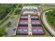 Red and blue pickleball courts with covered areas and adjacent parking at 6409 Wedgewood Dr, Spring Hill, FL 34606
