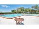 Community pool with lap lanes and a small table at 6409 Wedgewood Dr, Spring Hill, FL 34606