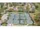 Aerial view of multiple tennis courts in a residential community at 6409 Wedgewood Dr, Spring Hill, FL 34606