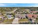 An aerial view showcasing the home, driveway, and surrounding neighborhood at 714 Charlotte Ave, Tarpon Springs, FL 34689