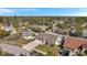 Elevated perspective of the home and fenced backyard with driveway at 714 Charlotte Ave, Tarpon Springs, FL 34689