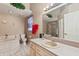 Bathroom featuring a large soaking tub, vanity, and tiled shower at 714 Charlotte Ave, Tarpon Springs, FL 34689