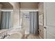 Bathroom with a shower/tub combo, single vanity, and tiled walls at 714 Charlotte Ave, Tarpon Springs, FL 34689