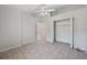 A bedroom with light gray walls, tiled flooring and open closet at 714 Charlotte Ave, Tarpon Springs, FL 34689