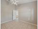 Empty bedroom with tile flooring, ceiling fan, and open doorway at 714 Charlotte Ave, Tarpon Springs, FL 34689
