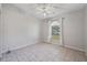 Bedroom with tiled flooring, ceiling fan, and large arched window at 714 Charlotte Ave, Tarpon Springs, FL 34689