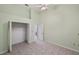 Bedroom with tiled flooring, ceiling fan, and open closet at 714 Charlotte Ave, Tarpon Springs, FL 34689