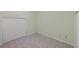 A bedroom with light green walls, tiled flooring, and white blinds at 714 Charlotte Ave, Tarpon Springs, FL 34689