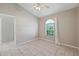 Bedroom with tiled flooring, ceiling fan, and arched window at 714 Charlotte Ave, Tarpon Springs, FL 34689