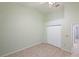 Bedroom featuring vaulted ceilings, tiled flooring and white closet doors at 714 Charlotte Ave, Tarpon Springs, FL 34689