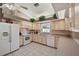 Kitchen with light wood cabinets, white appliances, and ample counter space at 714 Charlotte Ave, Tarpon Springs, FL 34689
