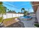 Above-ground pool with surrounding patio and white fence at 714 Charlotte Ave, Tarpon Springs, FL 34689