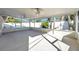 Large screened porch with fans, concrete flooring, and pool view at 714 Charlotte Ave, Tarpon Springs, FL 34689