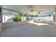 Spacious screened porch with concrete flooring and ceiling fans at 714 Charlotte Ave, Tarpon Springs, FL 34689