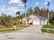 High-angle view of the home's exterior, showcasing the landscaped yard, driveway, and surrounding neighborhood at 7717 Foxbear Ct, New Port Richey, FL 34655