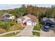 High-angle view of the property and surrounding neighborhood, showcasing the home's exterior, yard, and neighboring properties at 7717 Foxbear Ct, New Port Richey, FL 34655