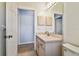 Bathroom featuring a single vanity, mirror, and light fixtures at 7717 Foxbear Ct, New Port Richey, FL 34655