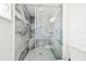 Modern bathroom with a glass-enclosed shower and gray marble tile at 7717 Foxbear Ct, New Port Richey, FL 34655