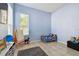 bedroom featuring blue walls, a bed, toys, and a window at 7717 Foxbear Ct, New Port Richey, FL 34655