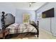 Bedroom with blue walls, a dark wood bed, and two windows providing ample natural light at 7717 Foxbear Ct, New Port Richey, FL 34655