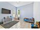 bedroom with blue walls, a toddler bed, toys, and a gray rug at 7717 Foxbear Ct, New Port Richey, FL 34655