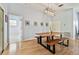 Dining room with a modern wood and metal table, light gray walls, and wood flooring at 7717 Foxbear Ct, New Port Richey, FL 34655