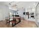 Open-concept dining area with a unique live-edge table and modern light fixture at 7717 Foxbear Ct, New Port Richey, FL 34655