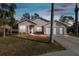 Charming single-story home with a two-car garage and landscaped front yard at 7717 Foxbear Ct, New Port Richey, FL 34655