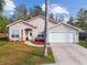 Charming single-story home with a palm tree and landscaped front yard at 7717 Foxbear Ct, New Port Richey, FL 34655