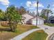 Elevated view of a single-story home with palm trees, landscaping, and a mailbox at 7717 Foxbear Ct, New Port Richey, FL 34655