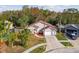 Aerial view of a single-Gathering home with a driveway, garage, and lush landscaping at 7717 Foxbear Ct, New Port Richey, FL 34655