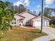 Aerial view of a single-story home with palm trees and a landscaped yard at 7717 Foxbear Ct, New Port Richey, FL 34655