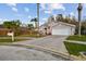 Charming home with a two-car garage, fenced yard, and landscaped front lawn at 7717 Foxbear Ct, New Port Richey, FL 34655