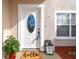Welcoming front entry with a white door, decorative window, and a 