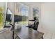 Home office or workspace situated in a bright corner with large windows overlooking greenery at 7717 Foxbear Ct, New Port Richey, FL 34655