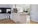 View of kitchen from living area, showing breakfast bar and wood-style flooring at 7717 Foxbear Ct, New Port Richey, FL 34655