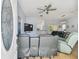 Inviting living area with comfy reclining chairs, a ceiling fan, and an open floorplan at 7717 Foxbear Ct, New Port Richey, FL 34655