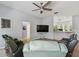 Living room featuring black and light green couches, a large TV, and wood-look floors at 7717 Foxbear Ct, New Port Richey, FL 34655