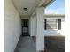 Covered entryway with tiled flooring and a door at 11423 Nest Ct, Port Richey, FL 34668