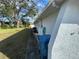 Side yard with grassy area and large trees at 11556 Linden Dr, Spring Hill, FL 34608