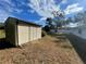 A view of a small shed in a grassy backyard at 11556 Linden Dr, Spring Hill, FL 34608