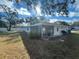 Backyard with a screened patio and a large grassy area at 11556 Linden Dr, Spring Hill, FL 34608