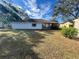 House backyard with a large green lawn at 11556 Linden Dr, Spring Hill, FL 34608