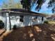 Backyard view of a house with mature trees at 11556 Linden Dr, Spring Hill, FL 34608