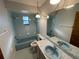 Light blue bathroom with bathtub, toilet and sink at 11556 Linden Dr, Spring Hill, FL 34608