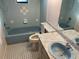 Bathroom with light blue tiled walls and a bathtub at 11556 Linden Dr, Spring Hill, FL 34608