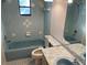 Bathroom with light blue tiled walls and a bathtub at 11556 Linden Dr, Spring Hill, FL 34608