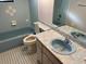 Bathroom with light blue tile, bathtub, toilet and sink at 11556 Linden Dr, Spring Hill, FL 34608