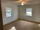 Bright bedroom with carpet, two windows, and ceiling fan at 11556 Linden Dr, Spring Hill, FL 34608