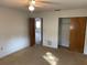 Bedroom with carpet, ceiling fan, and access to another room at 11556 Linden Dr, Spring Hill, FL 34608